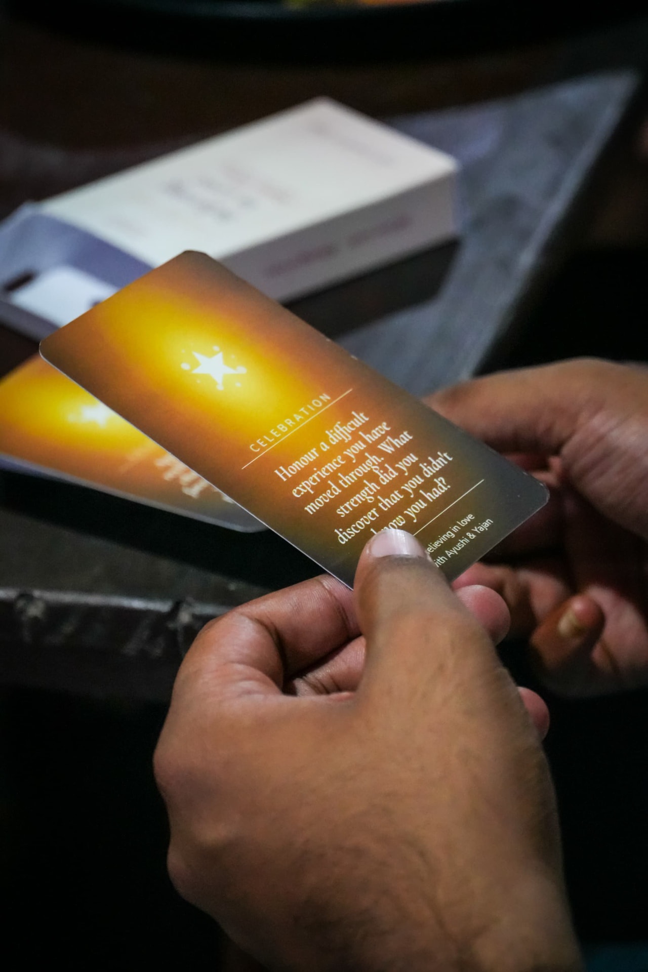 A guest reading a connection card by candlelight
