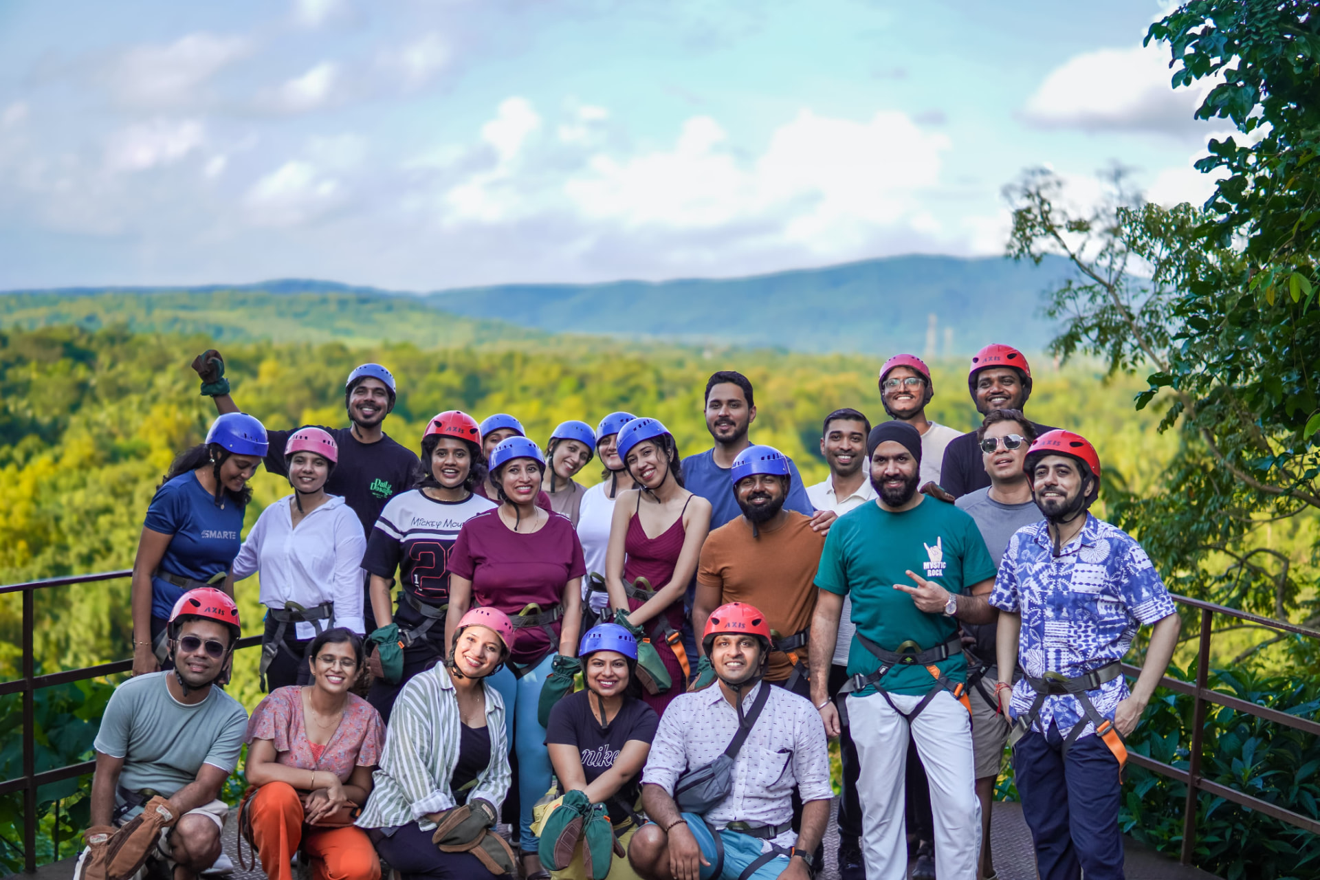 The group in helmets overlooking a green mountain valley