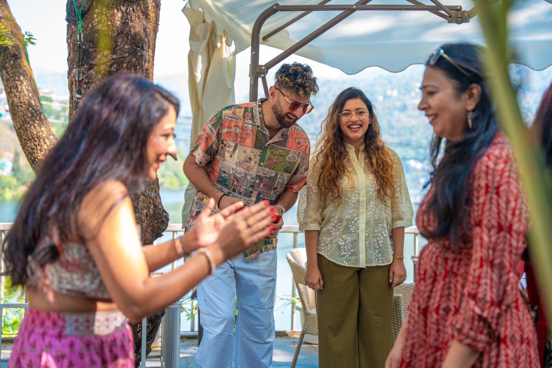 Guests laughing together on a terrace